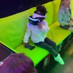 Young child using a VR headset inside the Streetside Gaming Bus