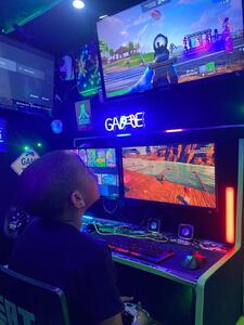 Child playing Fortnite on the gaming PC inside the Streetside Gaming Bus during an Easter treat party
