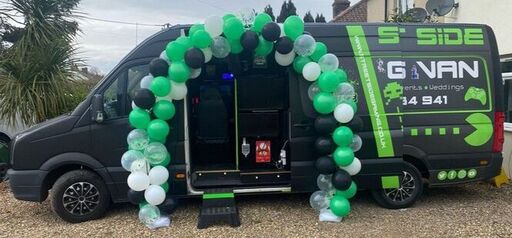Streetside Gaming Bus in Kirby-le-Soken decorated with green, black and white balloons