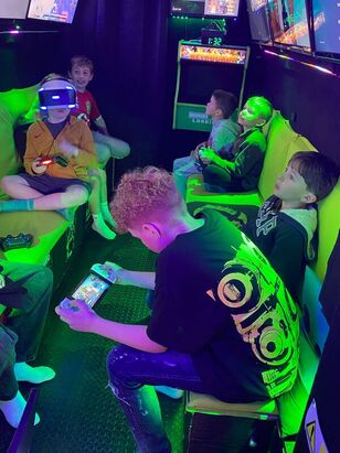 Children gaming together inside the Streetside Gaming Bus in Halstead