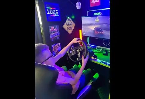 Child using the racing simulator inside the Streetside gaming bus in Colchester