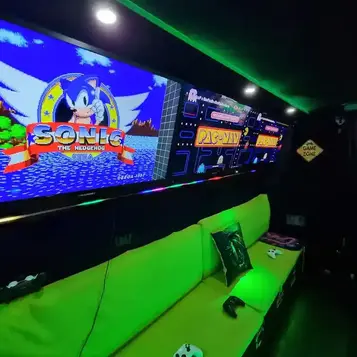 Retro arcade games including Sonic and Pac-Man displayed inside the StreetSide Gaming Bus