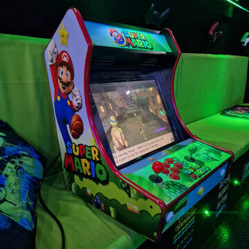 Super Mario retro arcade machine inside the Streetside Gaming Bus