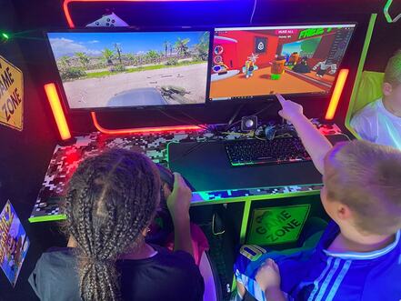 Children playing Roblox on the gaming PC inside the Streetside Gaming Bus