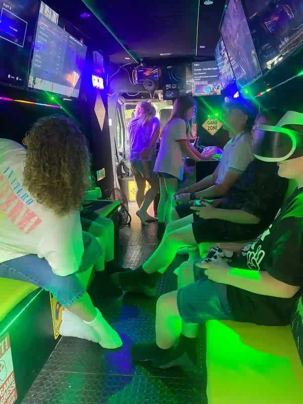 Children gaming together inside the Streetside Gaming Bus in Great Dunmow
