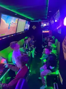 Children gaming together inside the Streetside Gaming Bus in Manningtree