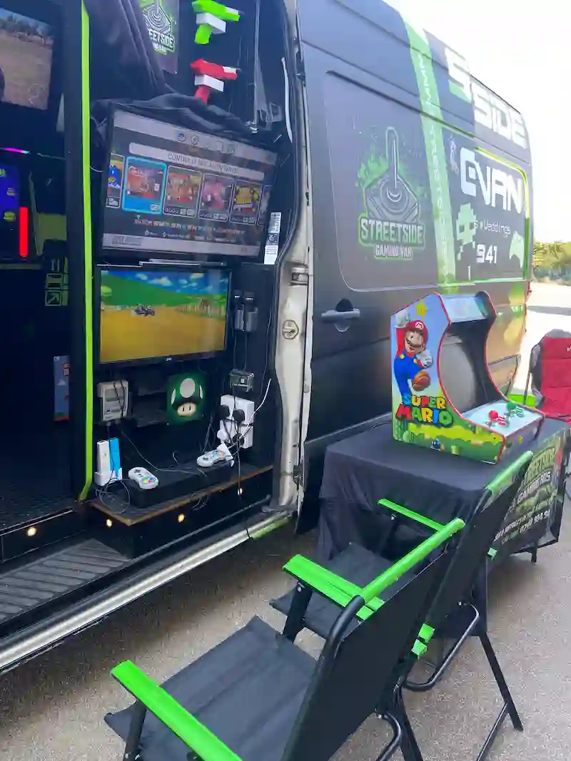 Streetside Gaming Bus with gaming screens and arcade machine at a HAF school holiday session